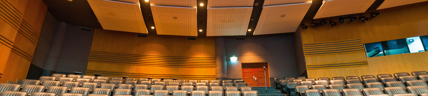 Auditorium with acoustically engineered ceiling panels and walls.