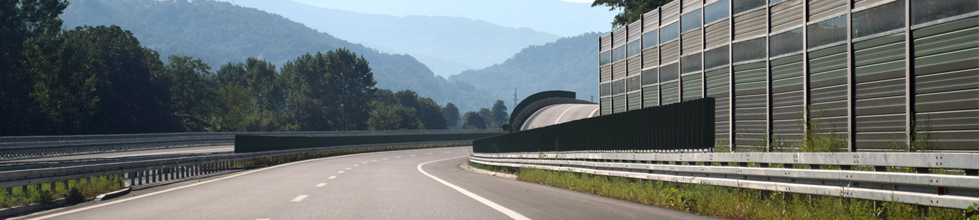 Highway with noise barrier to deflect excessive environmental noise issues.