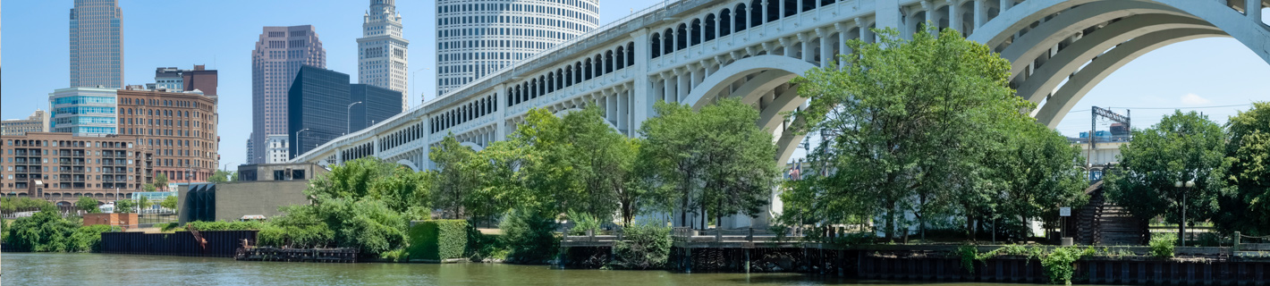 Cleveland, Ohio in distance beyond bridge over Cuyahoga River.