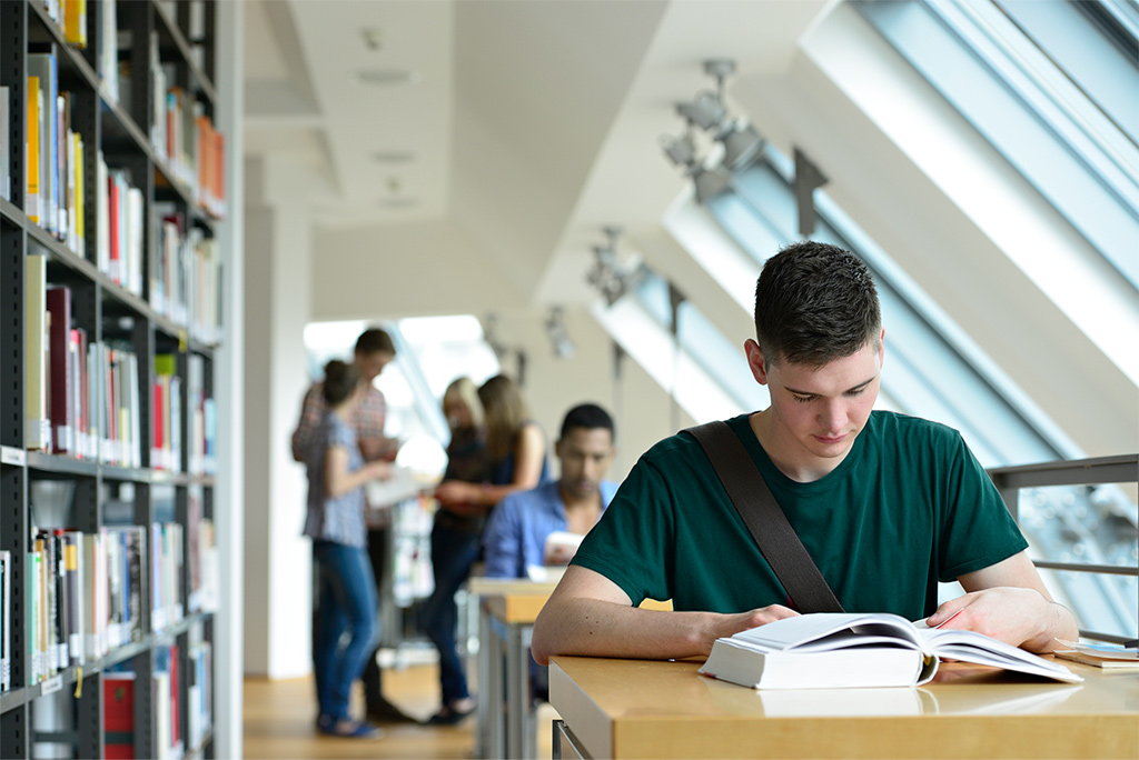 College student in library (media center.